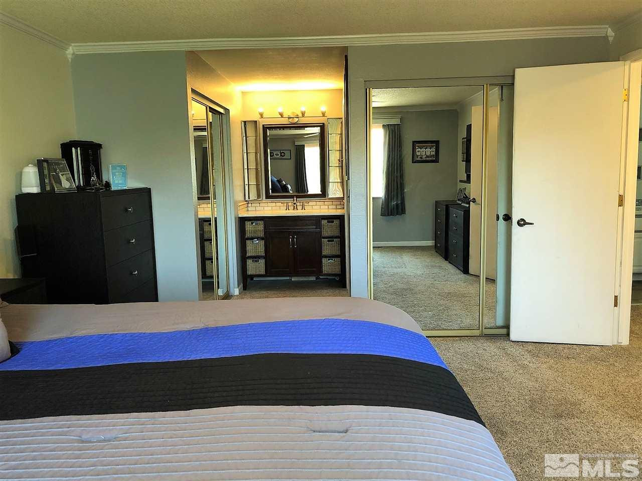 2180 Figoni Ranch Road, Unit NV Sparks, NV 89434 - Photo 19 of 39 a bedroom with a bed and a view of bathroom