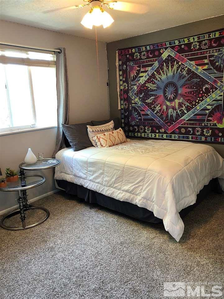 2180 Figoni Ranch Road, Unit NV Sparks, NV 89434 - Photo 23 of 39 a bedroom with a bed painting on wall and a large window