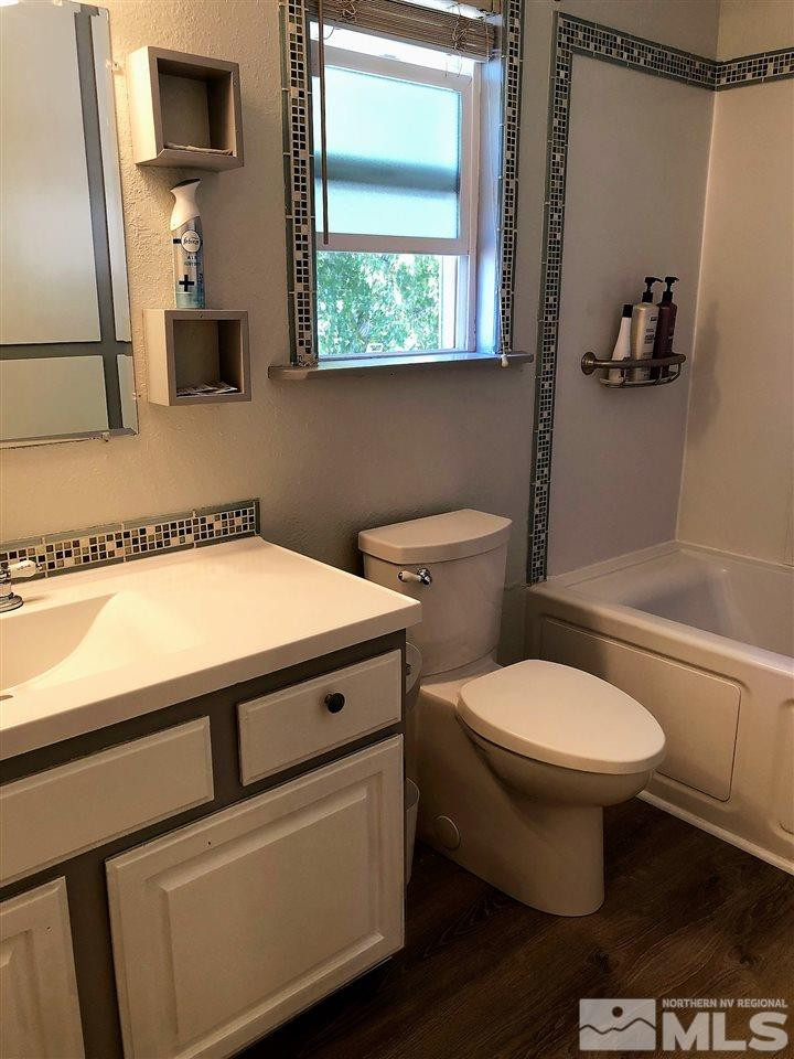 2180 Figoni Ranch Road, Unit NV Sparks, NV 89434 - Photo 25 of 39 a bathroom with a toilet a sink and a mirror