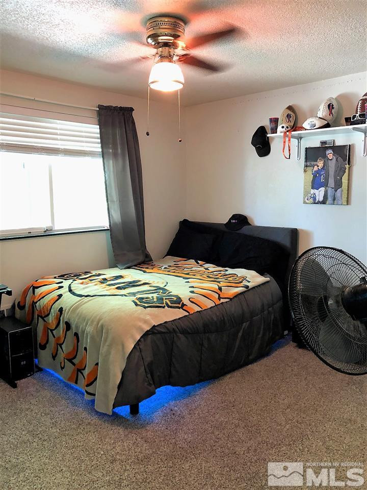 2180 Figoni Ranch Road, Unit NV Sparks, NV 89434 - Photo 26 of 39 a bedroom with a bed and a dresser