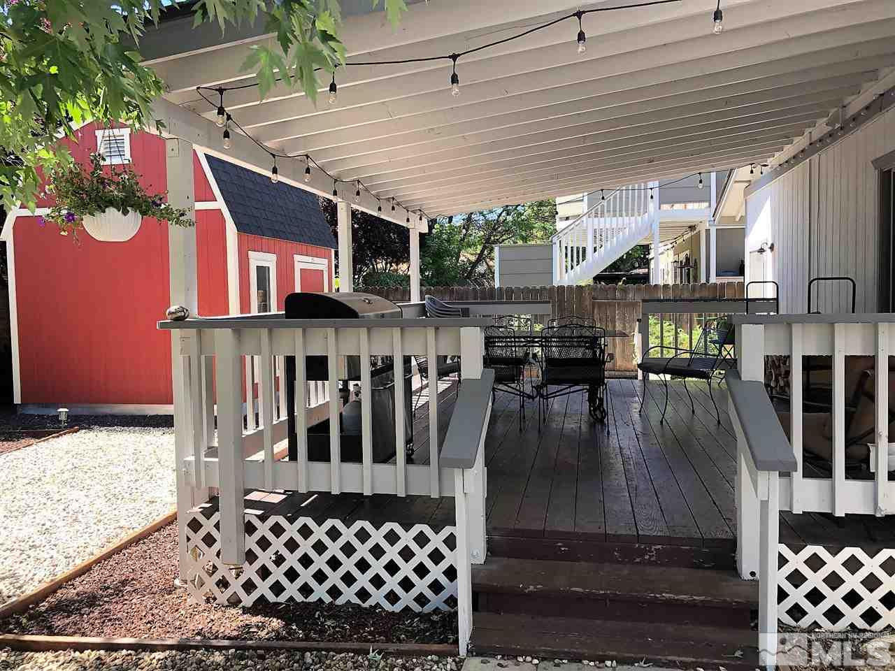 2180 Figoni Ranch Road, Unit NV Sparks, NV 89434 - Photo 32 of 39 a view of a patio with table and chairs with wooden floor