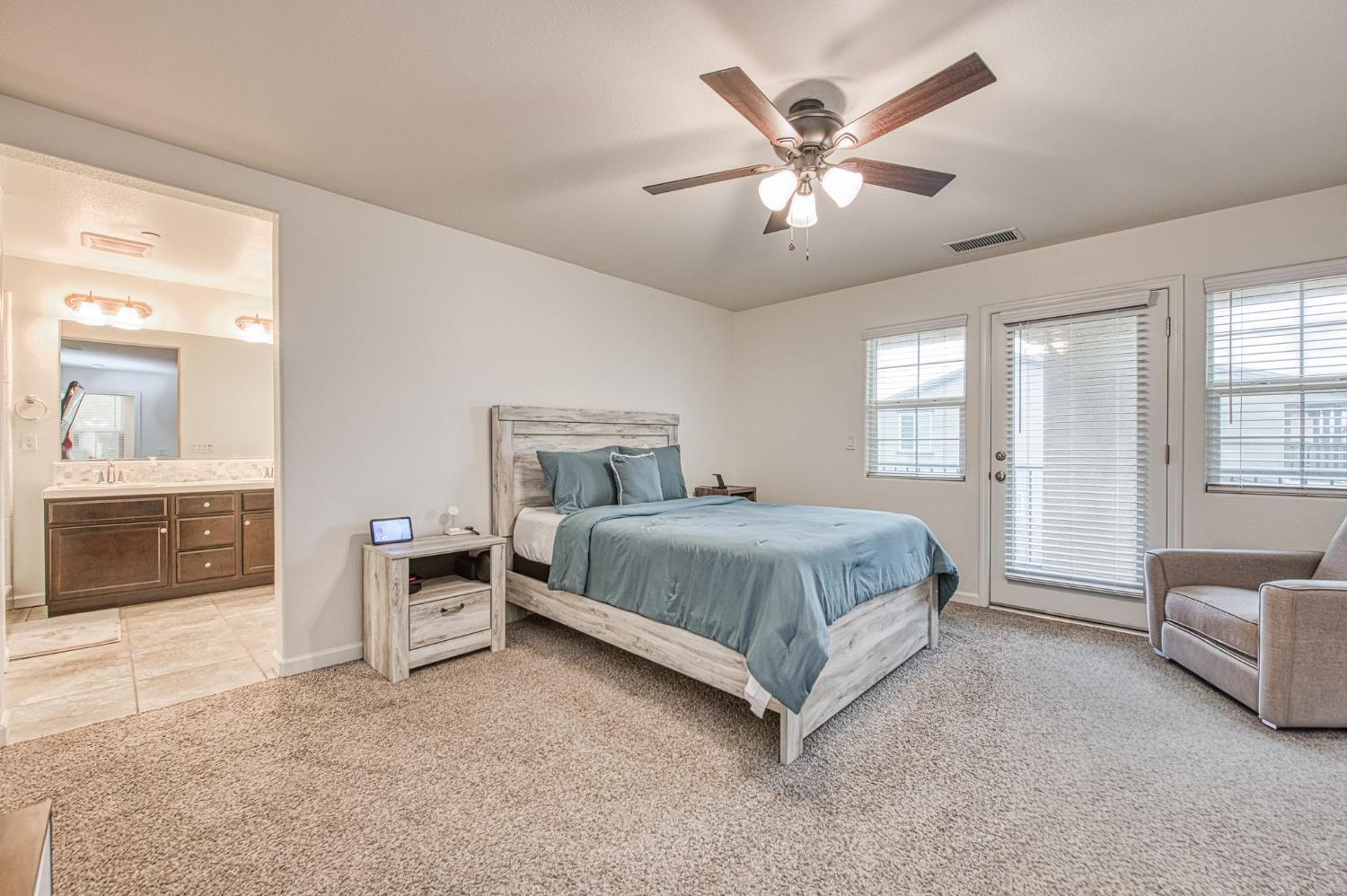 123 Capstone Way South Madera, CA 93636 - Photo 13 of 32 a spacious bedroom with a bed and glass door