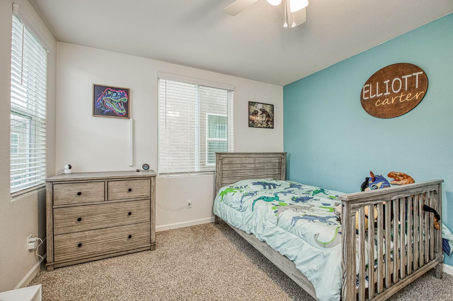 123 Capstone Way South Madera, CA 93636 - Photo 18 of 32 a bedroom with a bed and a chandelier