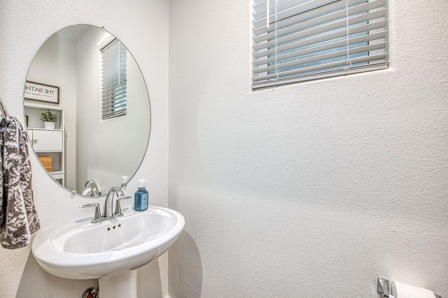 123 Capstone Way South Madera, CA 93636 - Photo 21 of 32 a bathroom with a sink and a mirror