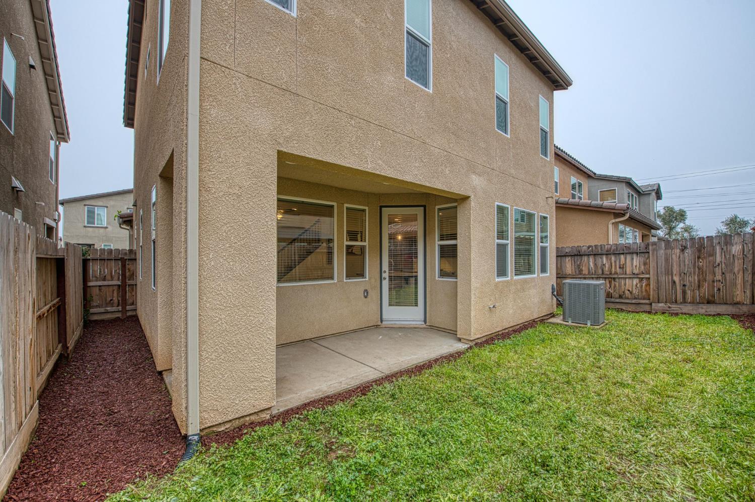 123 Capstone Way South Madera, CA 93636 - Photo 23 of 32 a view of backyard with barbeque grill and wooden fence