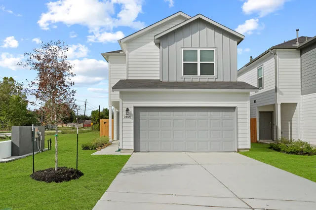 a front view of house with a yard and trees