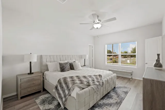 a bedroom with a large bed and a window