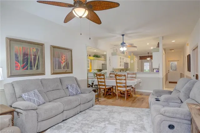 a living room with furniture and kitchen view