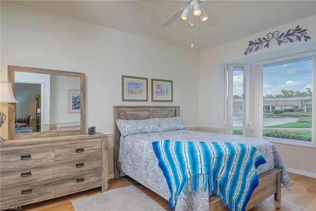 a bedroom with a bed and a large mirror on a dresser