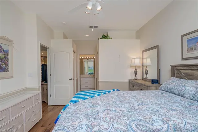 a bedroom with a large bed and dresser