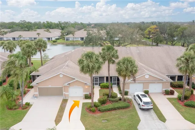 an aerial view of a house with outdoor space and lake view