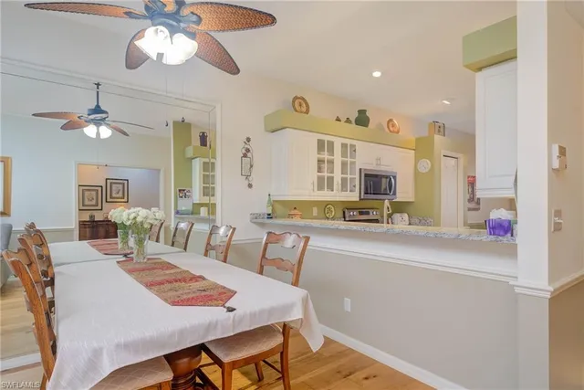 a view of a dining room with furniture and a chandelier