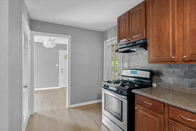 a kitchen with wooden cabinets and a stove top oven