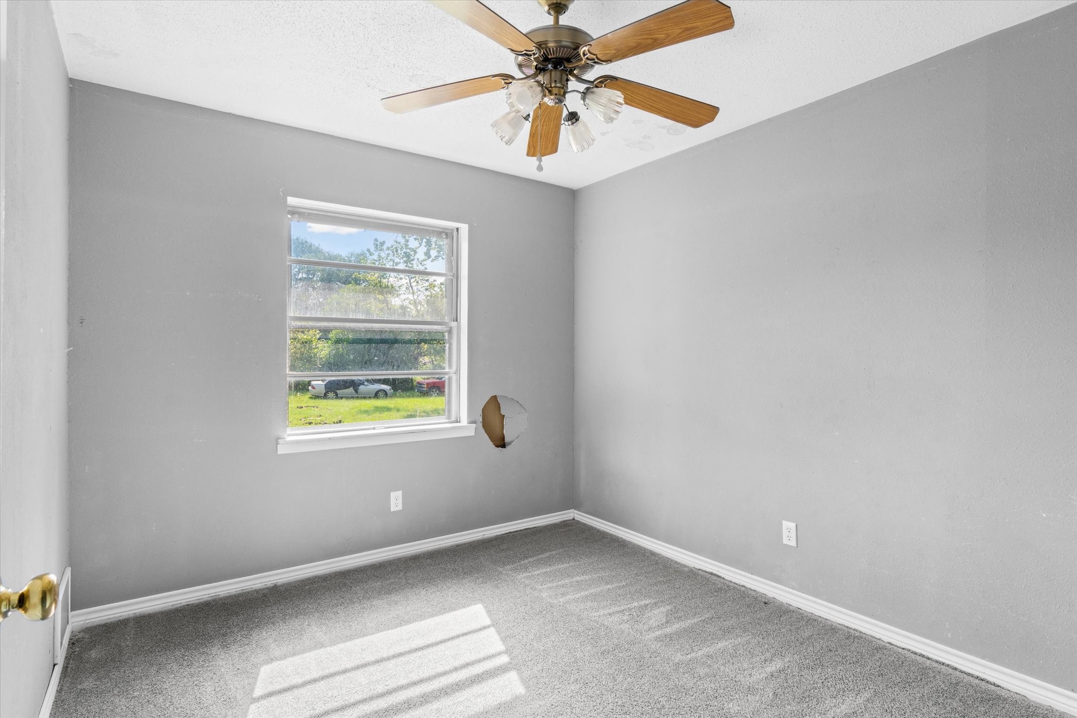 410 Williams Street Athens, TX 75751 - Photo 15 of 30 an empty room with a window and a fan