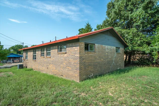 a view of a backyard with wooden fence