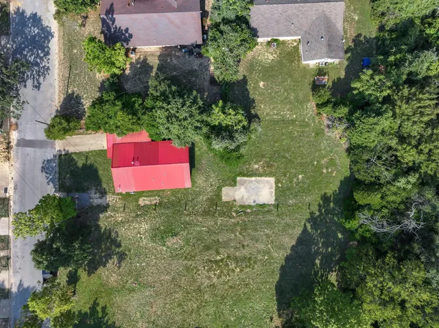 an aerial view of a house with a yard