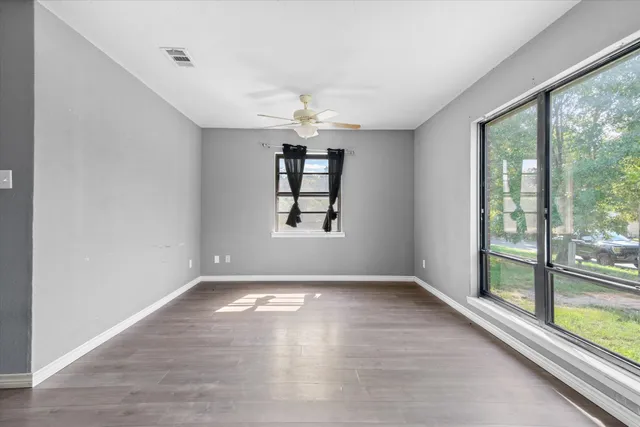 wooden floor in an empty room with a window