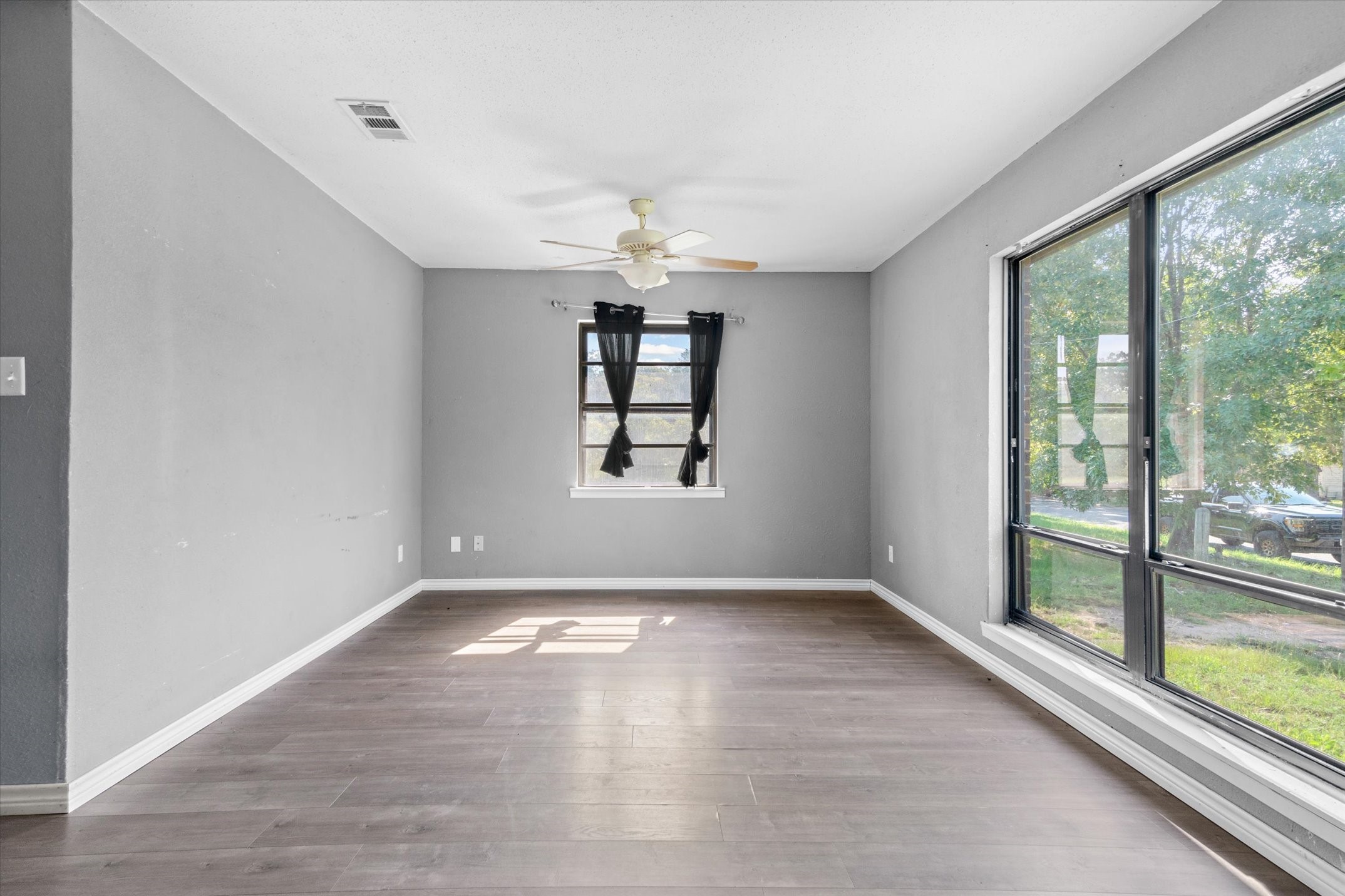 410 Williams Street Athens, TX 75751 - Photo 6 of 30 wooden floor in an empty room with a window
