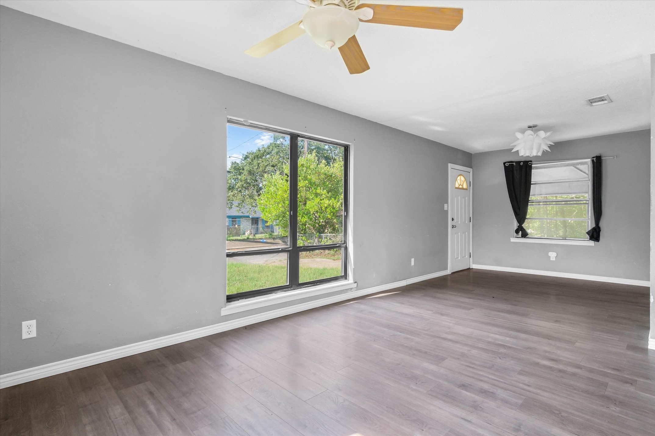 410 Williams Street Athens, TX 75751 - Photo 8 of 30 an empty room with wooden floor and windows