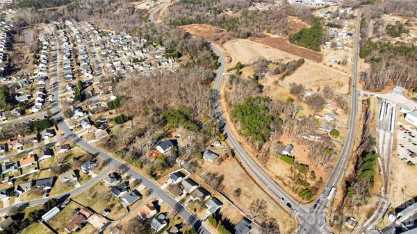 an aerial view of a residential houses with yard