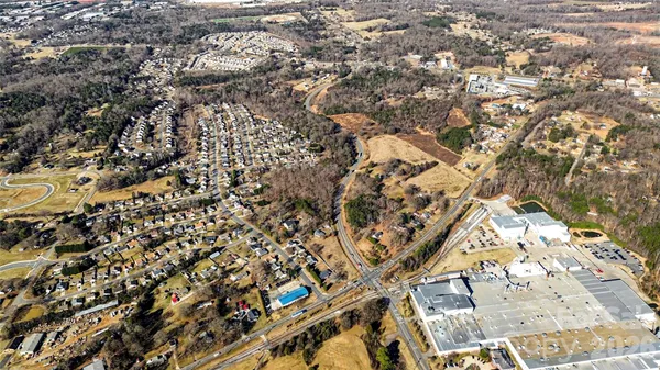 an aerial view of residential houses with city view