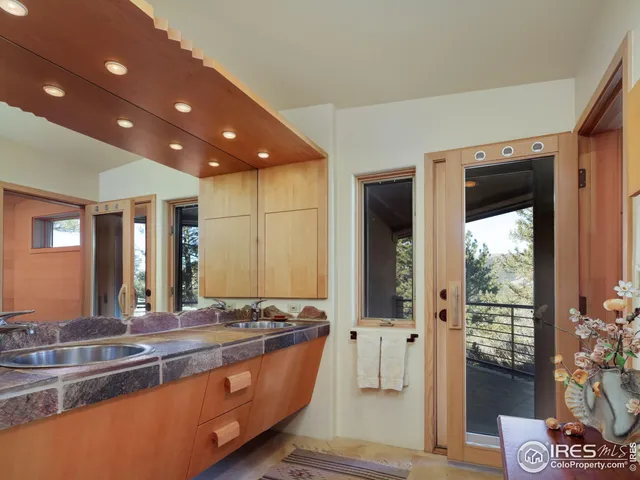 a spacious bathroom with a granite countertop sink and a large mirror