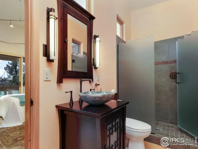 a bathroom with a sink toilet and mirror