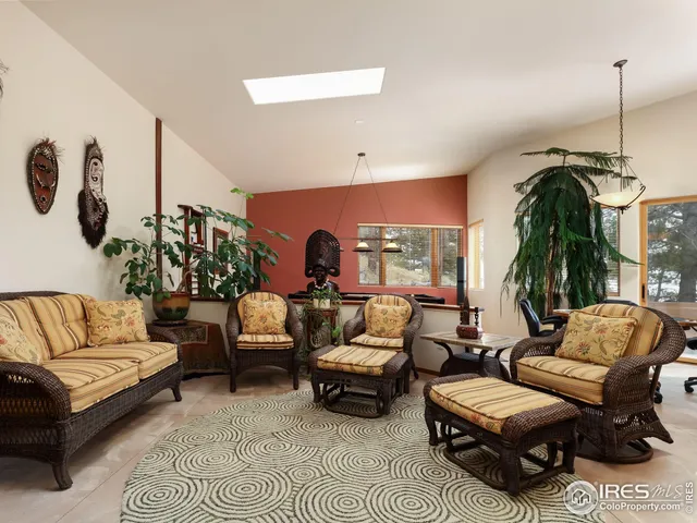 a room with furniture pool table and a flat screen tv