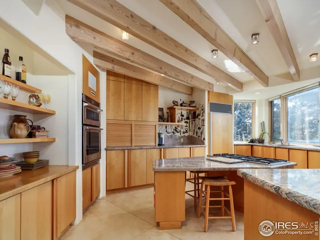 a kitchen with stainless steel appliances granite countertop a sink and a refrigerator