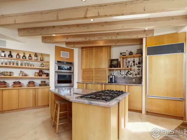 a kitchen with granite countertop a refrigerator and a stove