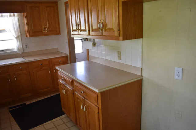 a kitchen with a sink and a window