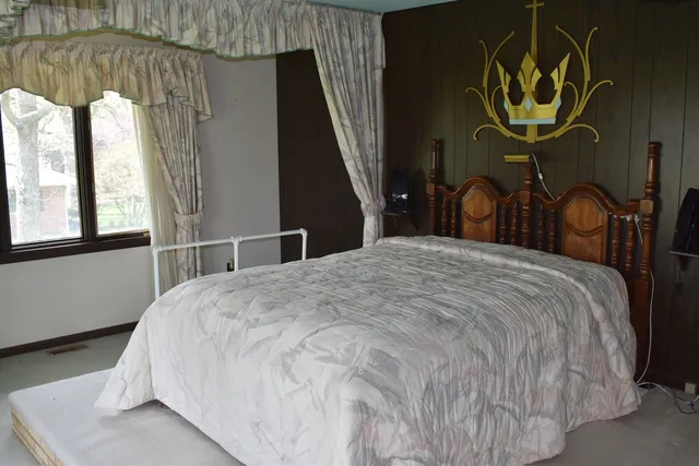 a bedroom with a bed and a window