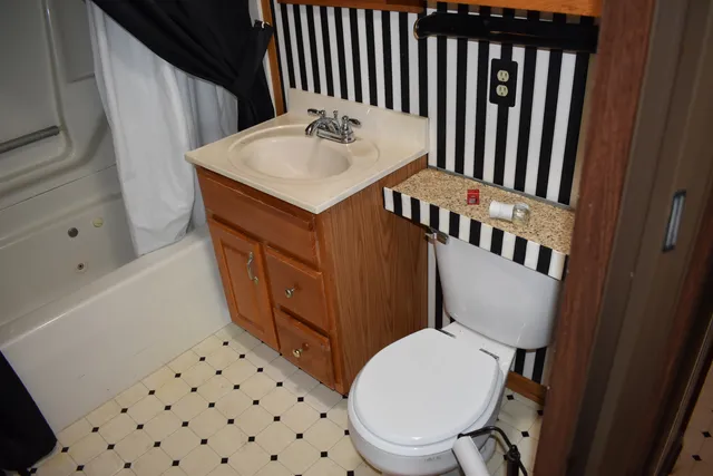 a white toilet sitting next to a bathroom sink