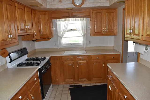 a kitchen with wooden cabinets and a stove top oven