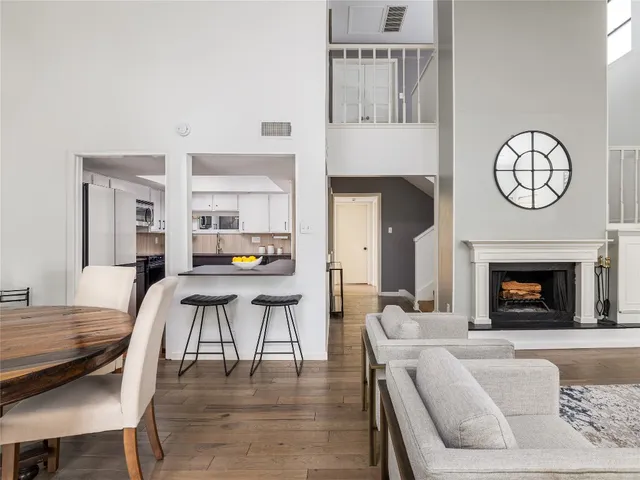 a living room with furniture a fireplace and a table