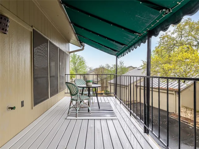 a view of a balcony with furniture and wooden floor