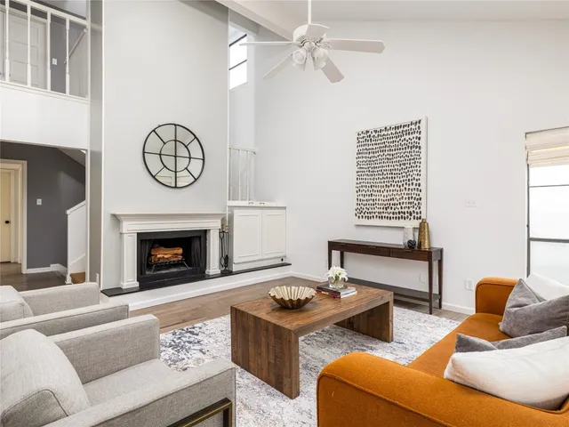 a living room with furniture a fireplace and a window