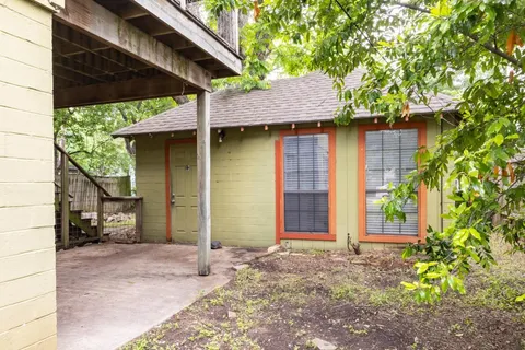 a view of a house with a small yard and plants