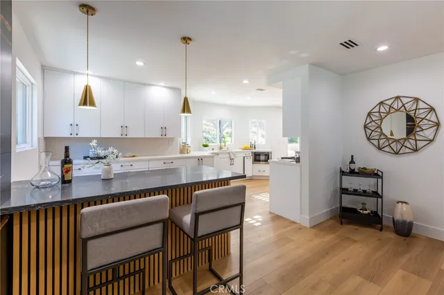 a kitchen with a table and chairs in it