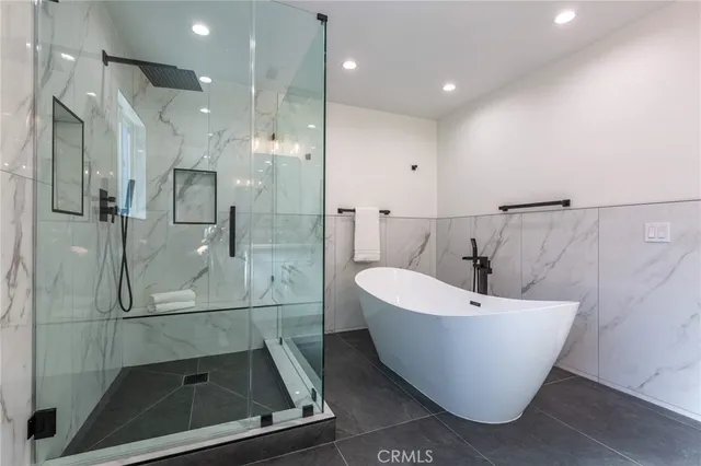a bathroom with a bathtub and shower