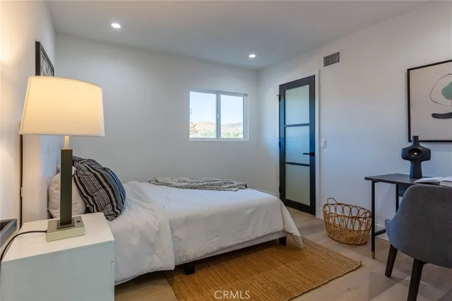 a bedroom with a bed and a lamp