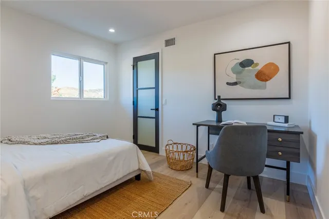 a bedroom with a bed and a table in it