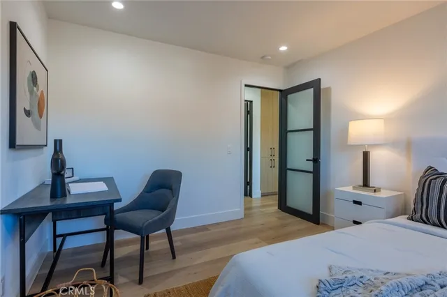 a bedroom with a bed a desk and chair