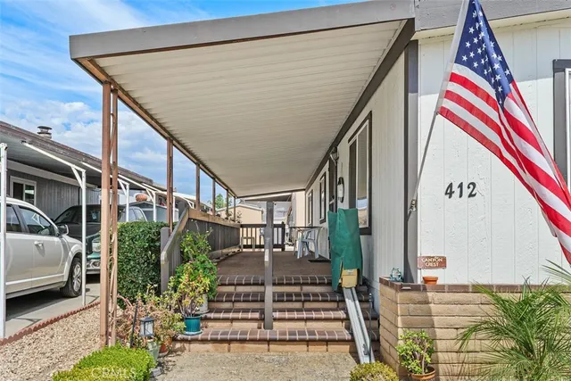 a view of balcony with wooden floor and potted plants