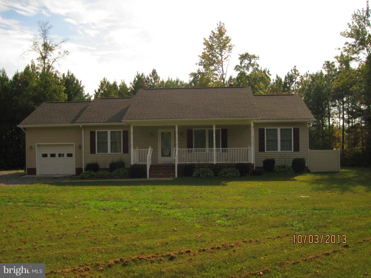 8192 Cedar Fork Road Ruther Glen, VA 22546 - Photo 1 of 28 a front view of a house with a garden