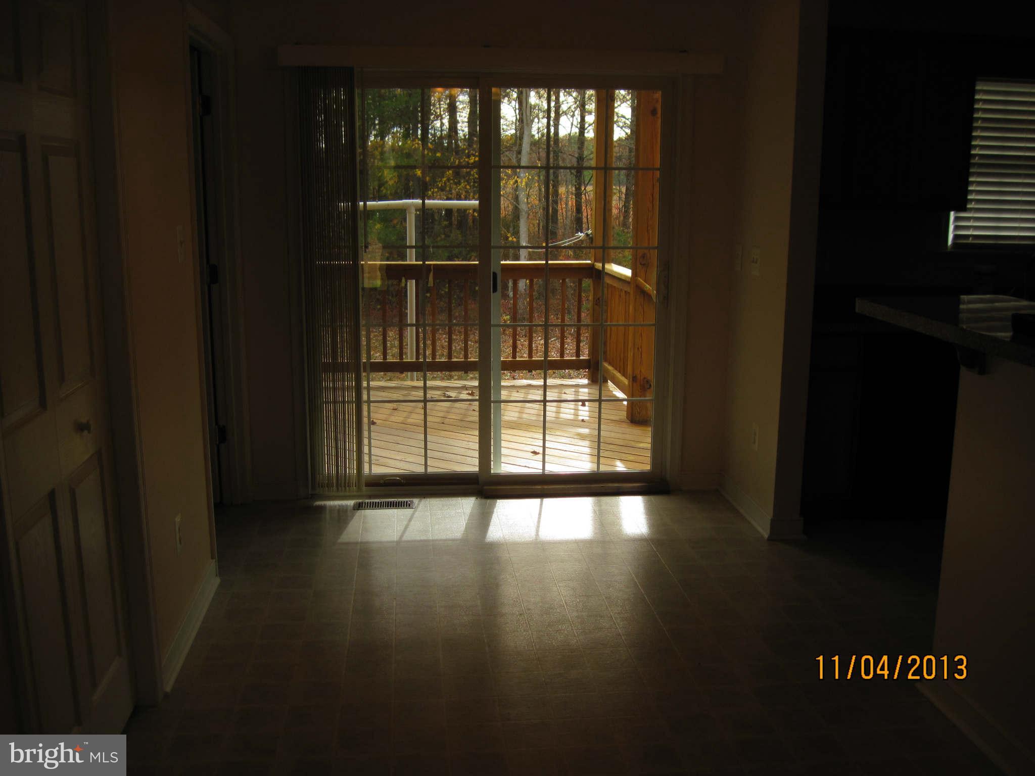 8192 Cedar Fork Road Ruther Glen, VA 22546 - Photo 10 of 28 a view of an empty room with wooden floor and a window