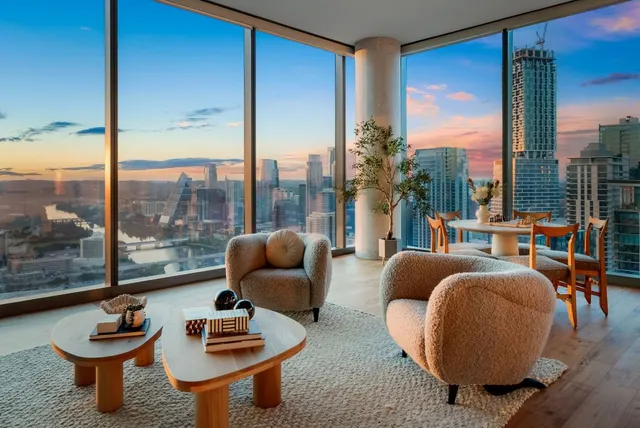a living room with furniture and a floor to ceiling window