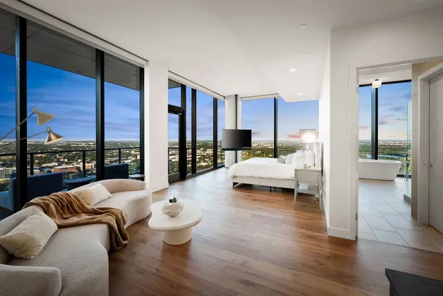 a bed room with a bed and a large window