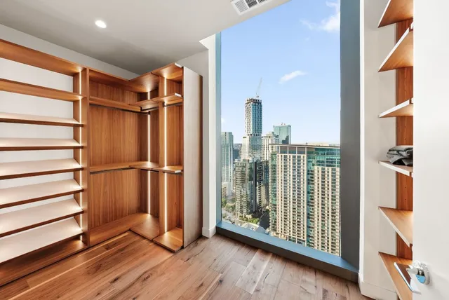 a view of a balcony with wooden chairs