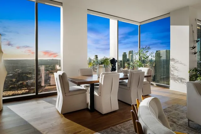 a dining room with furniture and a floor to ceiling window